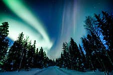 Northern Lights Aurora Borealis Activity Over The Road In Winter Finland Stock Image