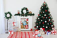 Christmas Tree With Gifts By The Fireplace For The New Year Decor Of The House Royalty Free Stock Photos