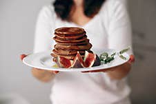 Chef Holding Pancakes In His Hands. Royalty Free Stock Photography