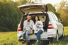 Family In A Summer Forest By The Open Trunk Stock Image