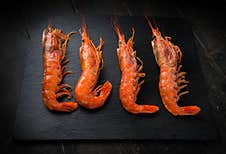 Large Langoustines On A Black Plate. Seafood Healthy Stock Photography