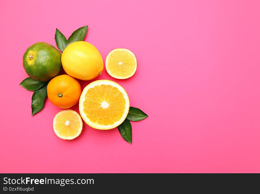 Beautiful lemon, orange, tangerine on pink background