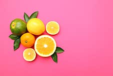 Beautiful Lemon, Orange, Tangerine On Pink Background Royalty Free Stock Photography