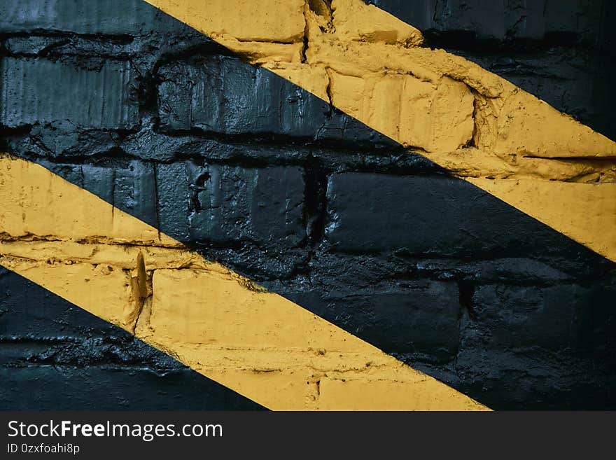 Black brick wall with yellow stripes at gym