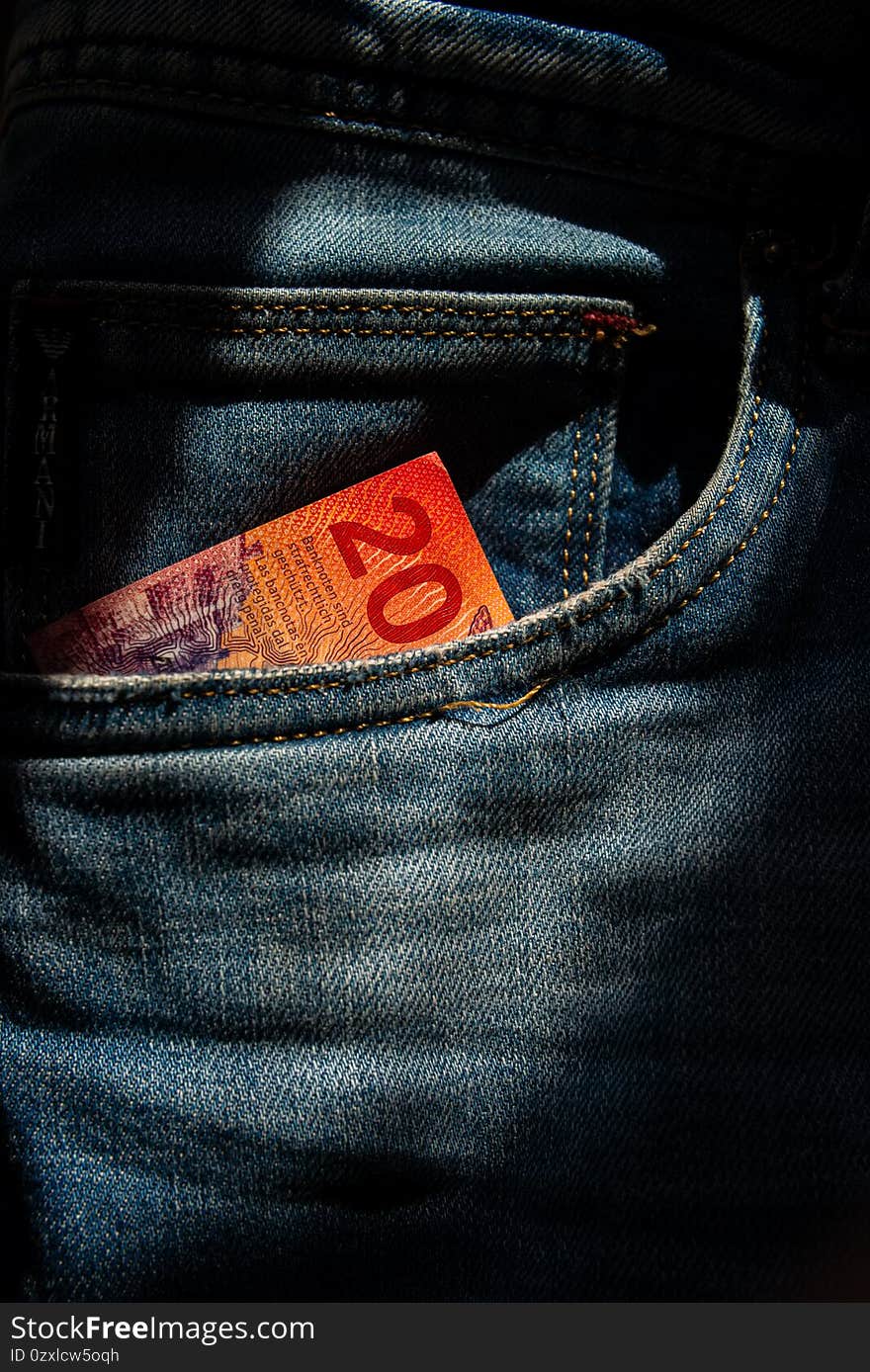 Twenty Swiss francs paper note in jeans pocket. Financial background