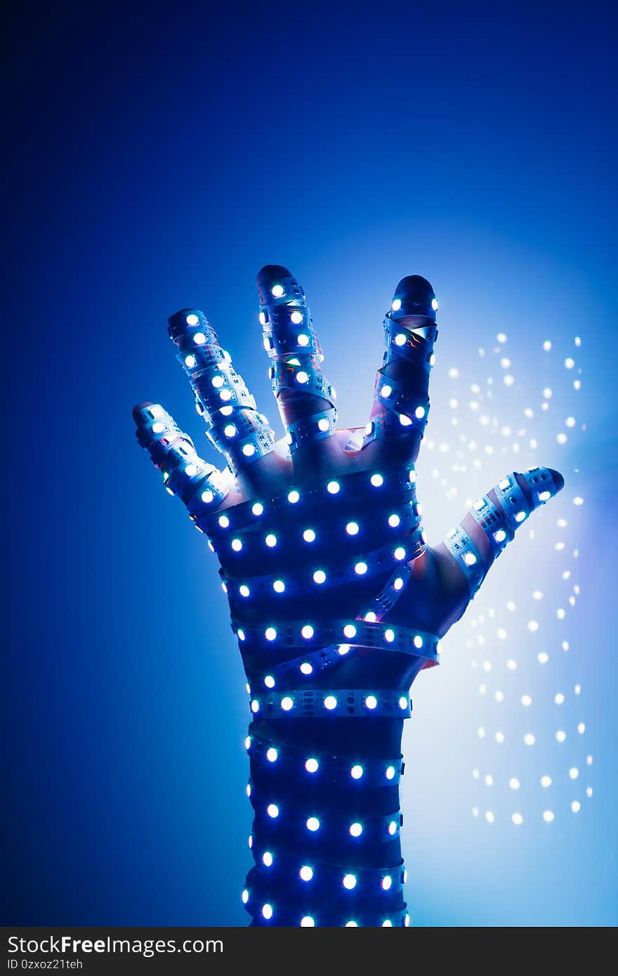 human hand covered with blue led lights, illuminated background