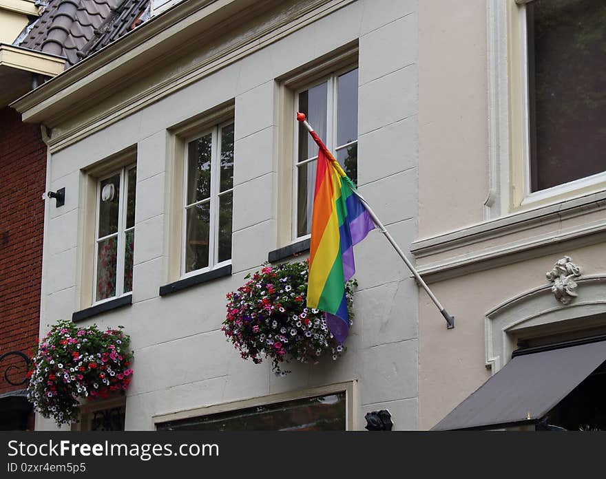 Flower baskets combined with a rainbow colored flag in Amersfoort