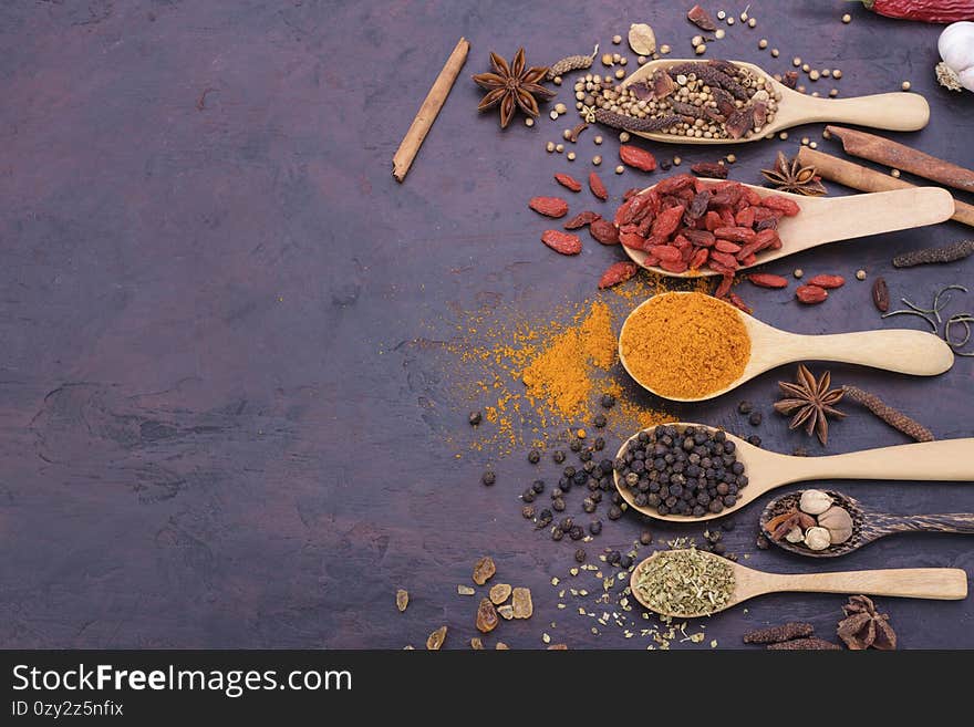 Spoon of assorted spices chili garlic salt kosher pepper paste on stone table top view with copy space.