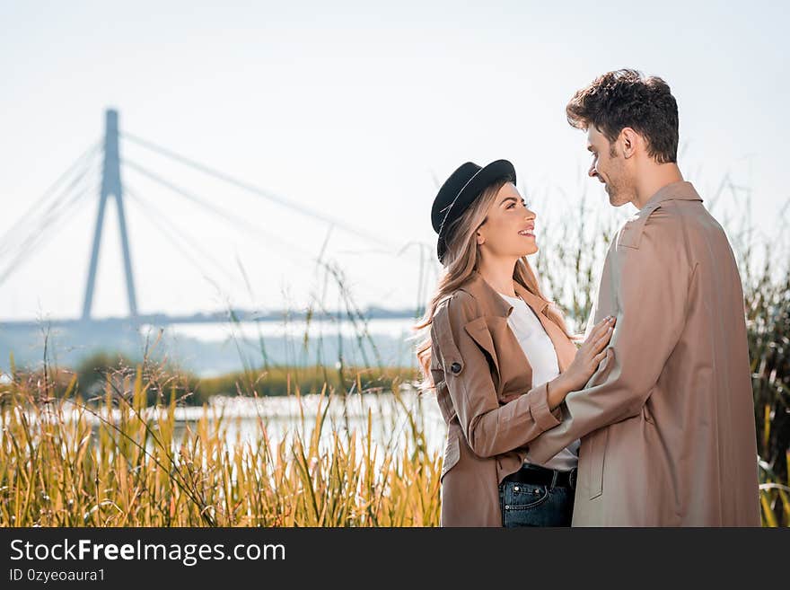 Woman in hat and man embracing