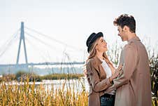 Woman In Hat And Man Embracing Royalty Free Stock Photos