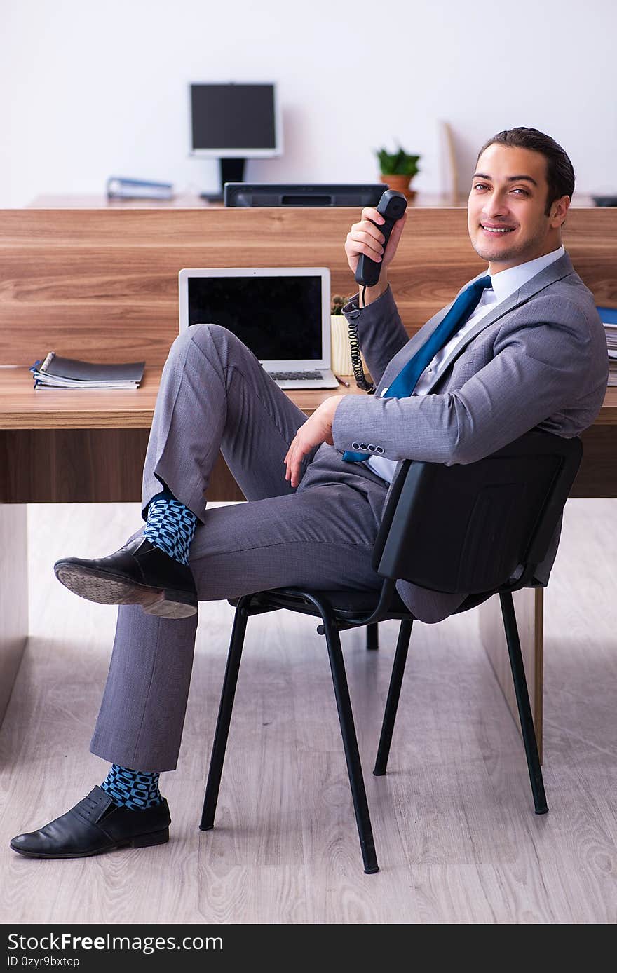 Young male employee working in the office