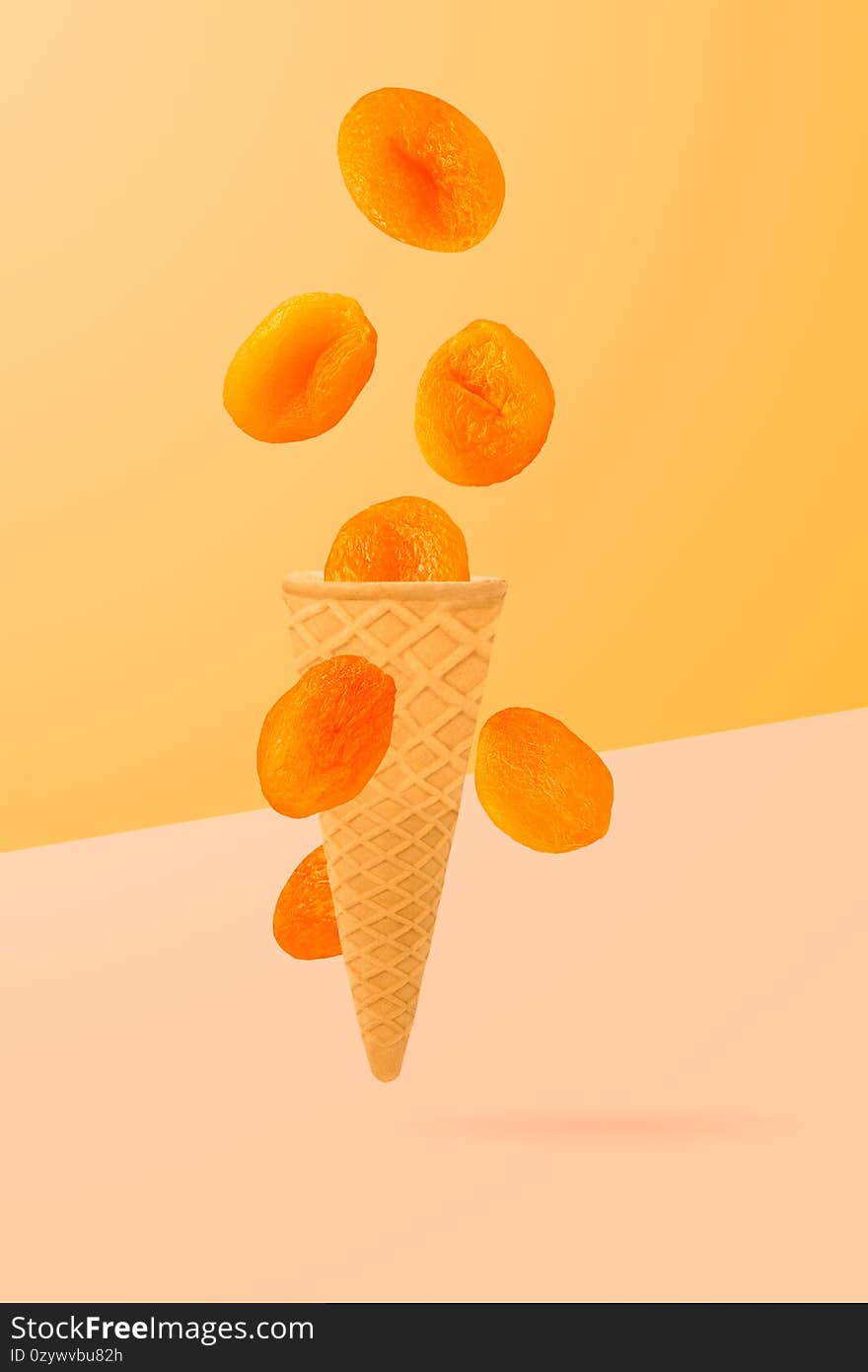 Sweet flying fruits in ice cream waffle cone in motion