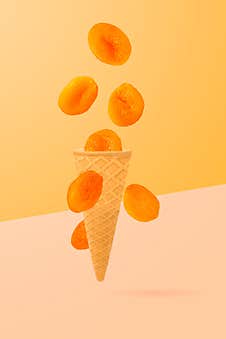 Sweet Flying Fruits In Ice Cream Waffle Cone In Motion Stock Photography