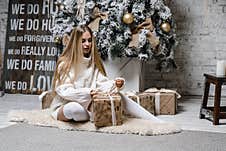 Young Beautiful Woman Model With Long Hair In Leggings Long Sweater Christmas Tree Christmas Royalty Free Stock Images