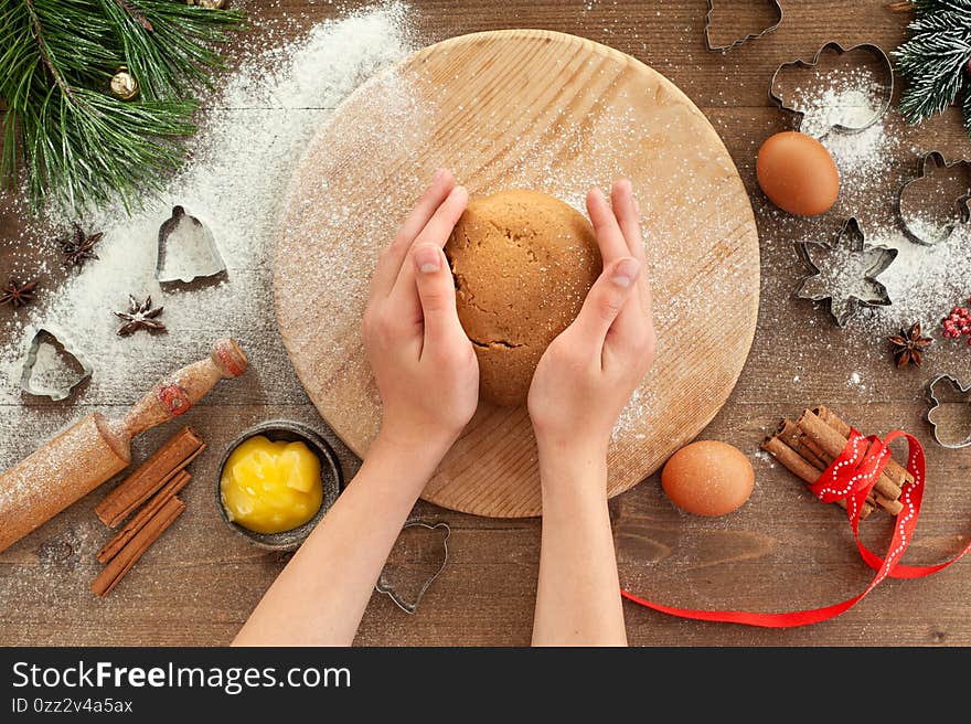 The process of cooking Christmas gingerbread. Christmas cooking on a brown wooden background.