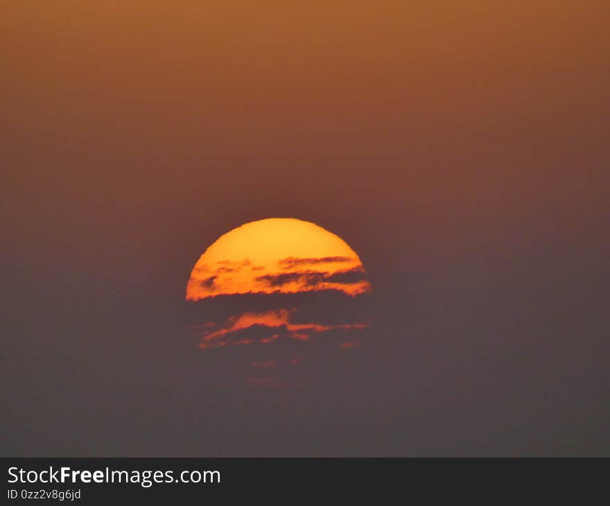 Photo of what looks like a fight between the sun and the clouds during a sunset in summer. This photograph was taken in the Camargue in Provence. Photo of what looks like a fight between the sun and the clouds during a sunset in summer. This photograph was taken in the Camargue in Provence