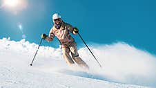 Woman Skiing On Mountain Top Stock Photo