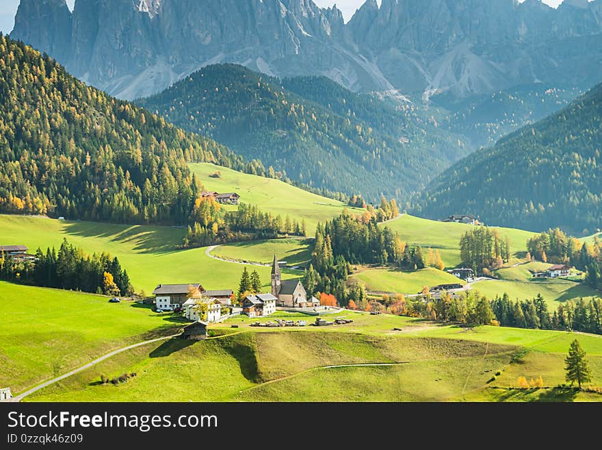 Landscape of early autumn in the village of Santa Magdalena in northern Italy on the slopes of the Dolomites in the valley of Val di Funes. Landscape of early autumn in the village of Santa Magdalena in northern Italy on the slopes of the Dolomites in the valley of Val di Funes.