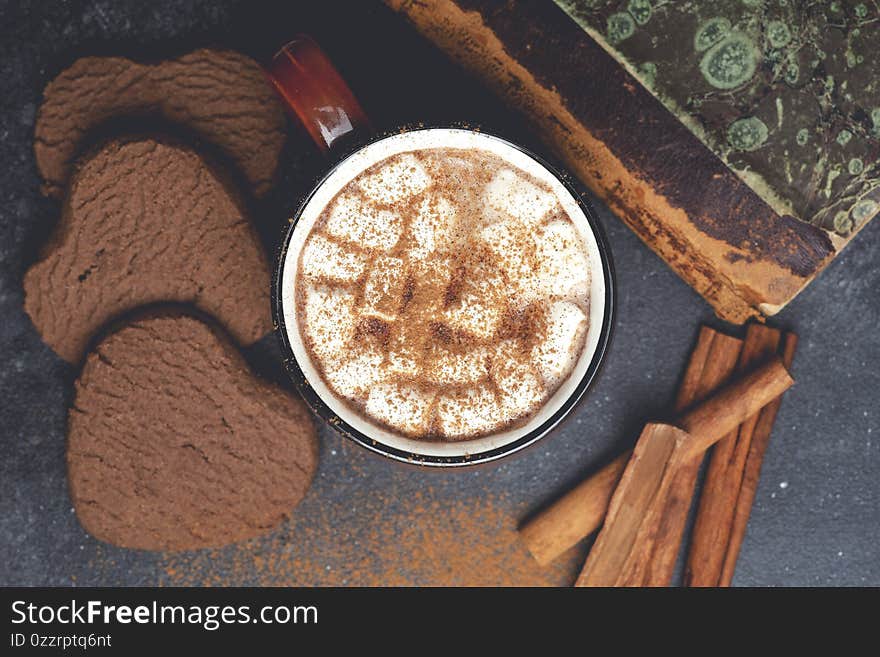 Hot chocolate cocoa drink backround. Cocoa drink on a dark background with cinnamon and whipping. Winter hot drinks