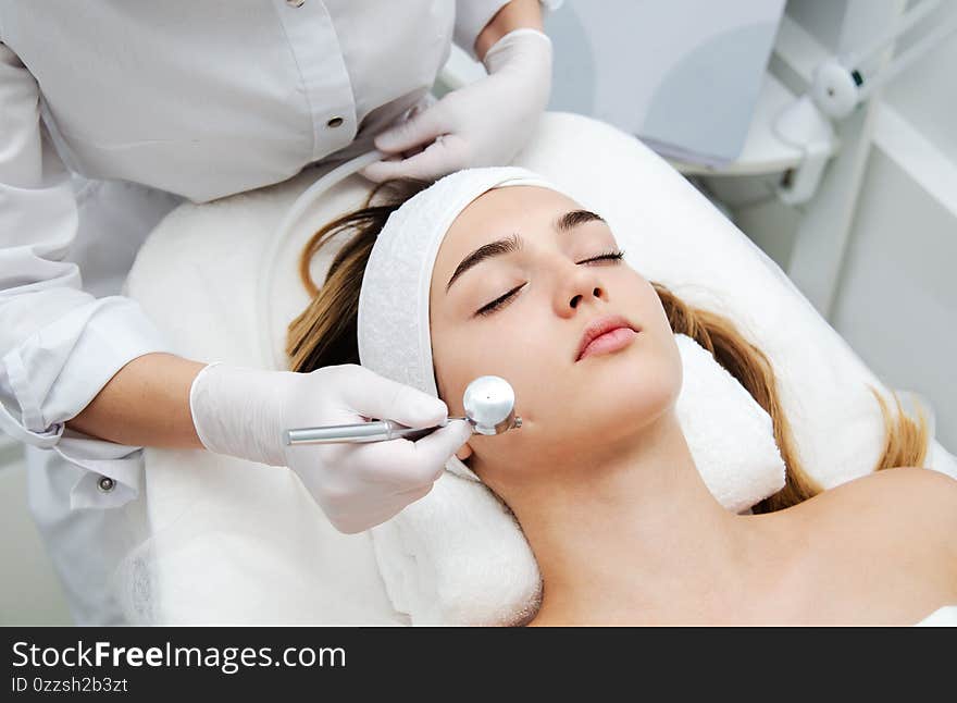 Woman getting face beauty treatment in medical spa center