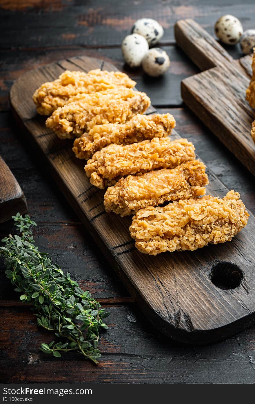 Fried chicken wings on dark wooden background