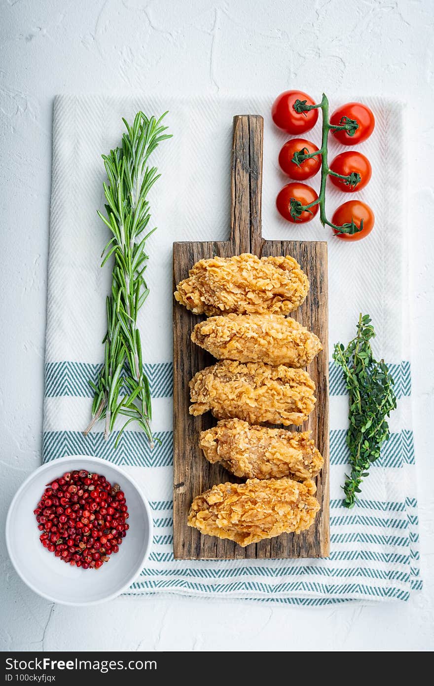 Spicy deep fried breaded chicken wings on white background, top view