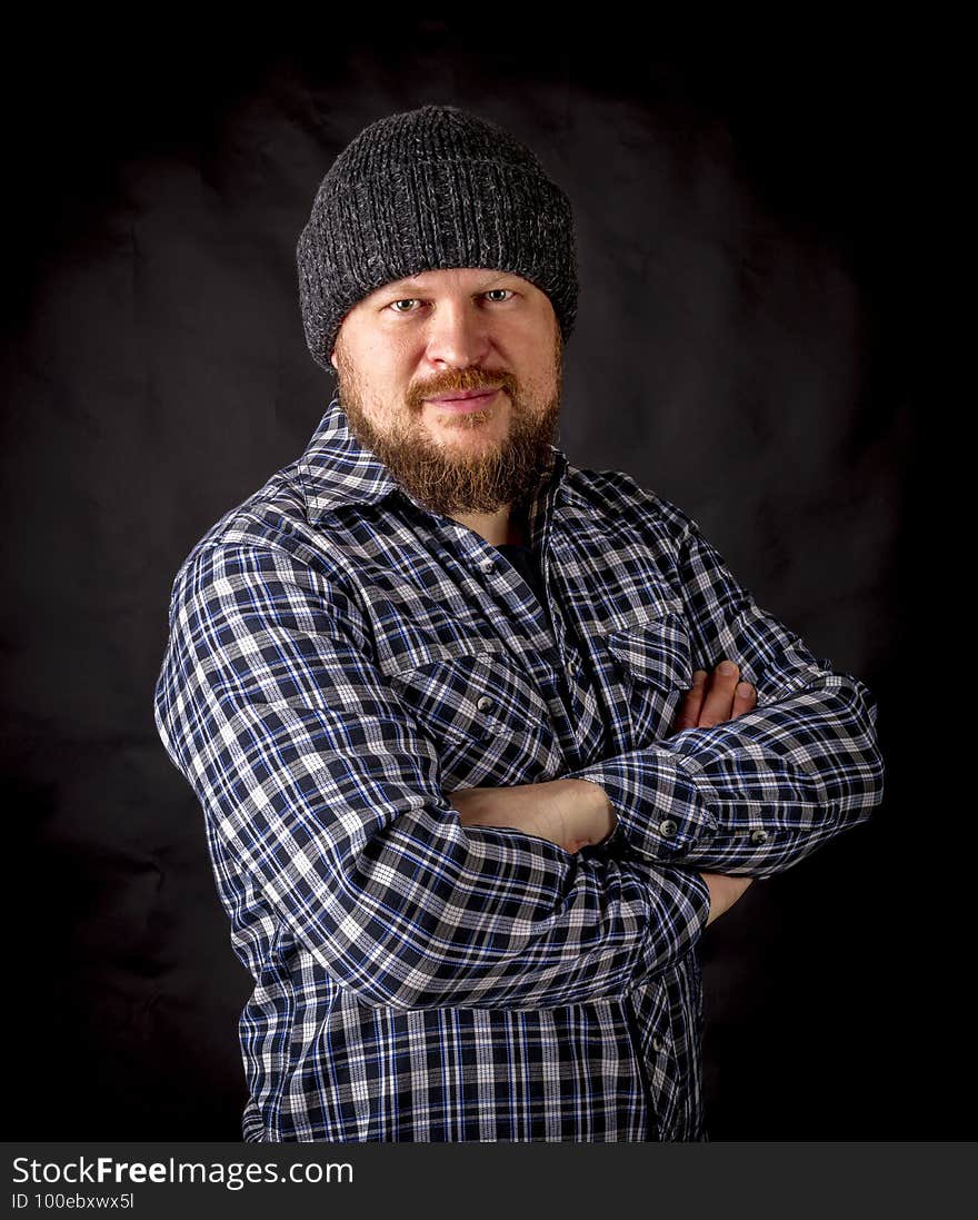 Solid bearded man in a wool cap portrait