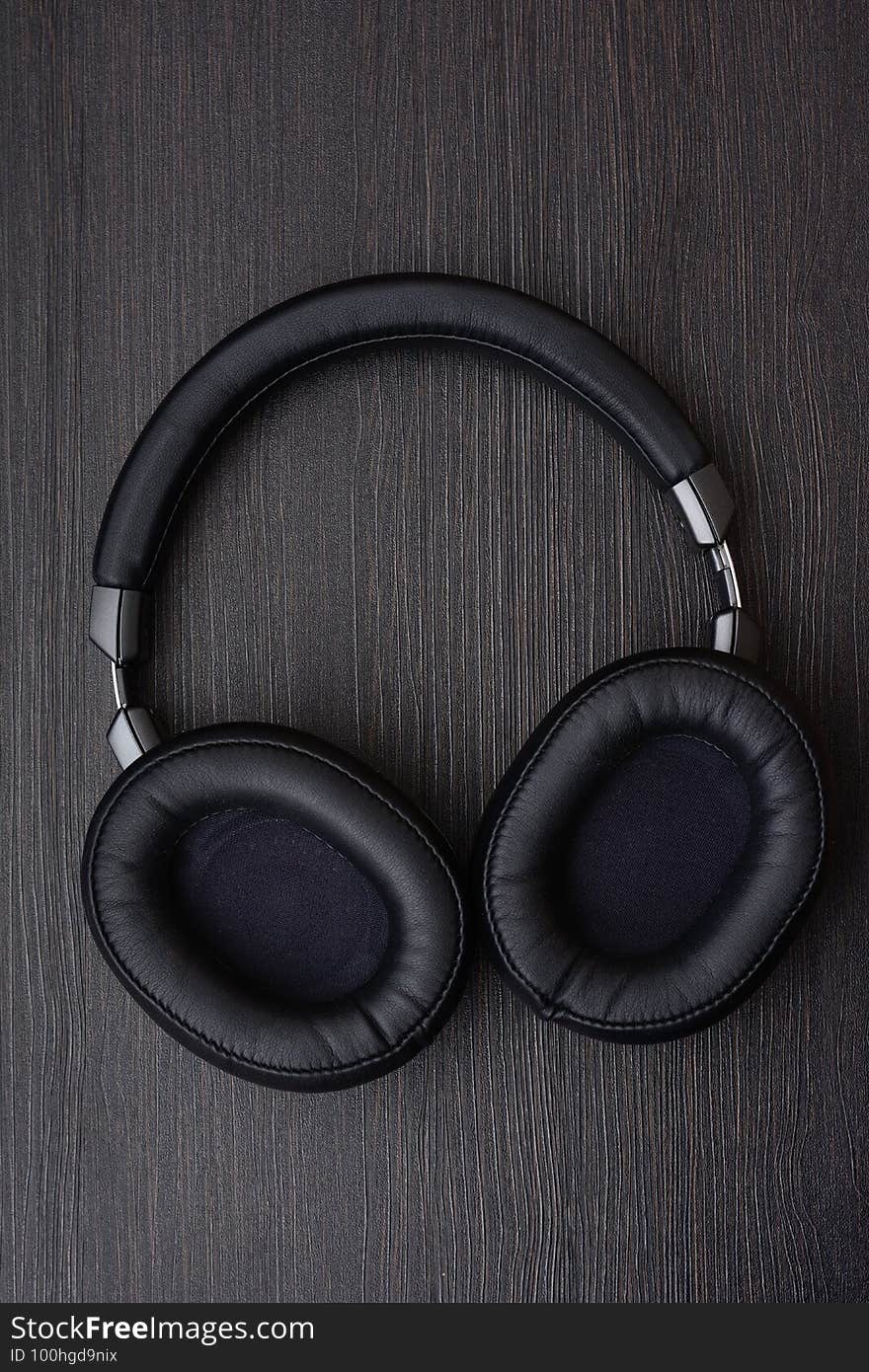 Wireless full-size headphones on a dark background, close-up