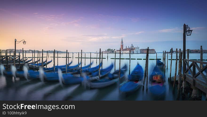 Venice lagoon, San Giorgio church and gondolas at sunrise. Italy