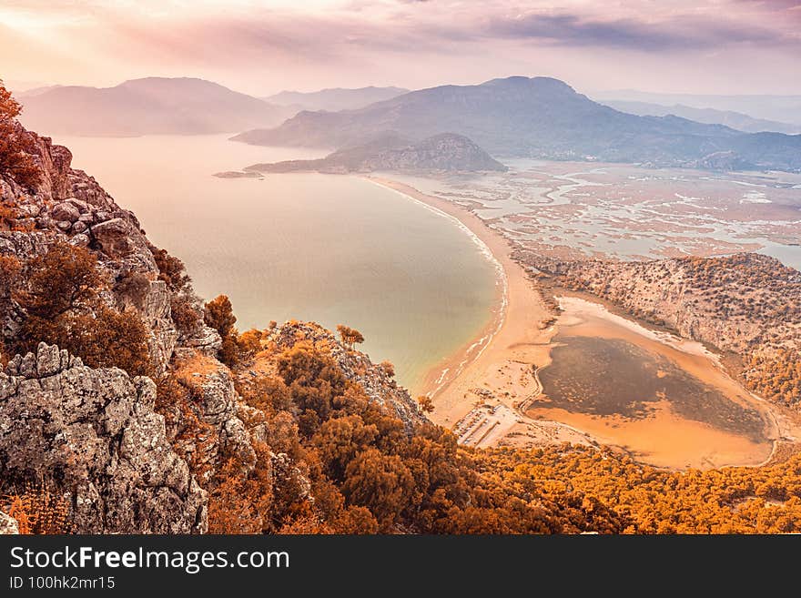 Aerial paniramic view from mountain Bozburun to Iztuzu beach and the Dalyan river Delta as well as lake Sulungur at sunset