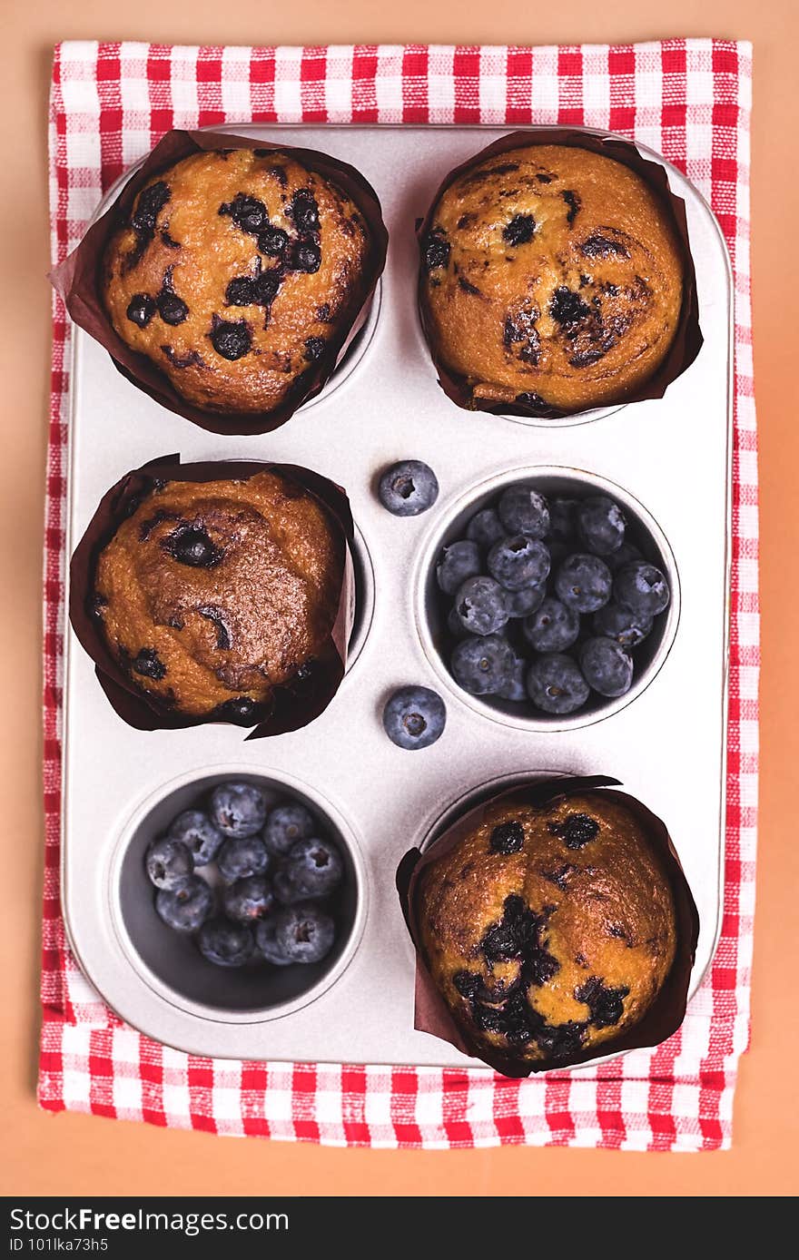 Homemade Blueberry Muffins with Berries Baking Dish Napkin Light Brown Background Top View Vertical