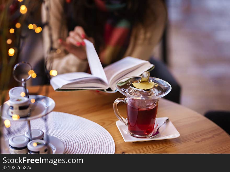 Close-up of cafe desk with tea and croissant