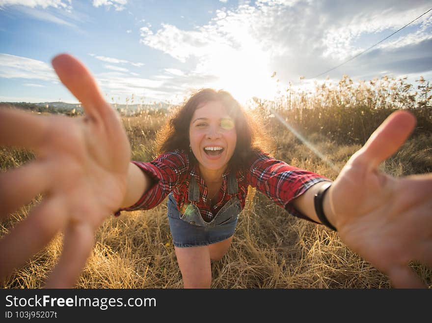 Travel, vacation and holiday concept - Funny young woman taking selfie over beautiful landscape