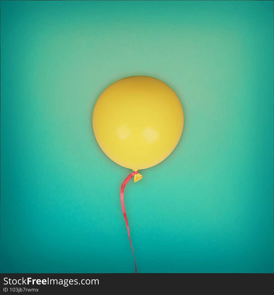 Bright yellow balloon on blue textured background. Bright yellow balloon on blue textured background