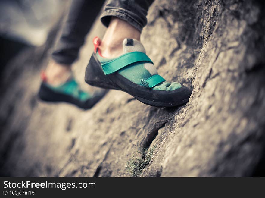 Person climbing while wearing rock climbing shoes