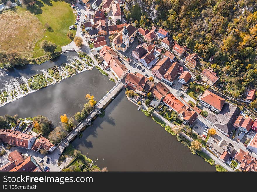 Image of an aerial view with a drone of the city view of the market Kallmünz Kallmuenz in Bavaria and the bridge over the rivers Naab and Vils and the castle ruin on the mountain, Germany.