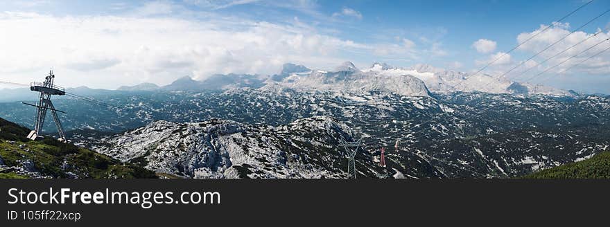 View from the Krippenstein mountain to the Dachstein mountain range. Panorama of high mountains with a permanent cover of ice.