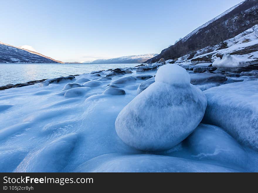 Beautiful winter landscape with icy shore of the fjord