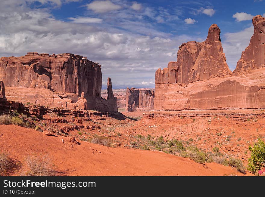 A scenic view on the Park Avenue trail in Arches National park against blue sky, USA