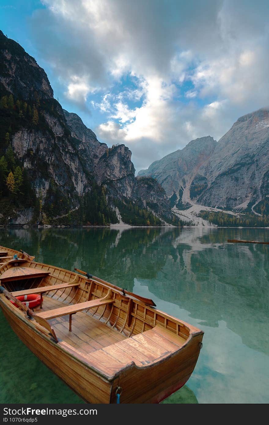 Italy. Dolomites mountains and a boat in Braes lake , Autumn landscape