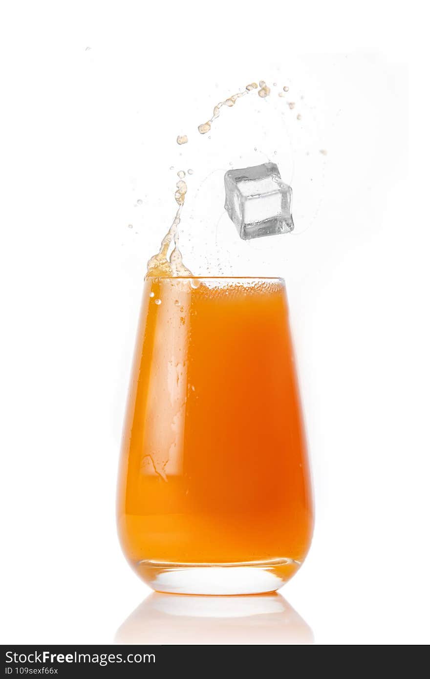 Glass of fruit juice with ice on a white background