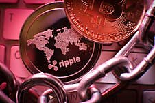 Ripple Cryptocurrency Coin On A Laptop Keyboard In A Red Colors . Falling Market. Financial Crisis. Stock Photos