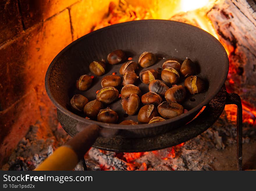 Chestnuts grilling on the smoldering fire, italian chestnut from Viterbo Area. Chestnuts grilling on the smoldering fire, italian chestnut from Viterbo Area