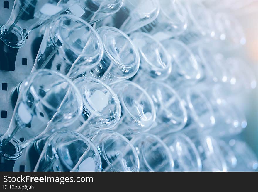 Glass flask in medical research lab or science laboratory. Blue tone. Selective focus