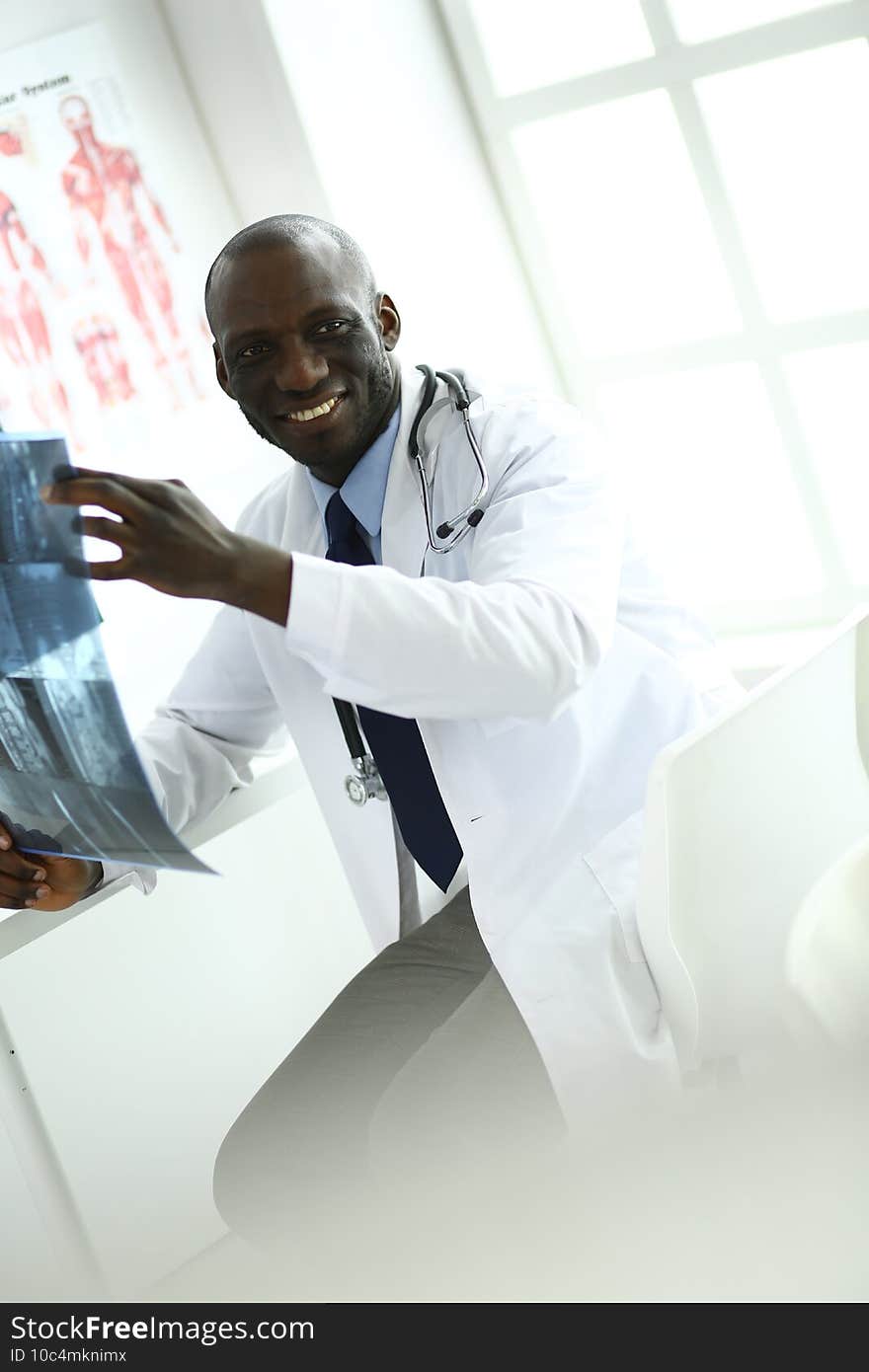 Portrait young african medical doctor holding patient`s x-ray.