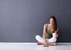 Woman Sitting On The Floor Using A Digital Tablet Stock Image