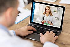 Online Medical Consultation. Male Patient Communicating To His Doctor On Laptop At Home Stock Photography