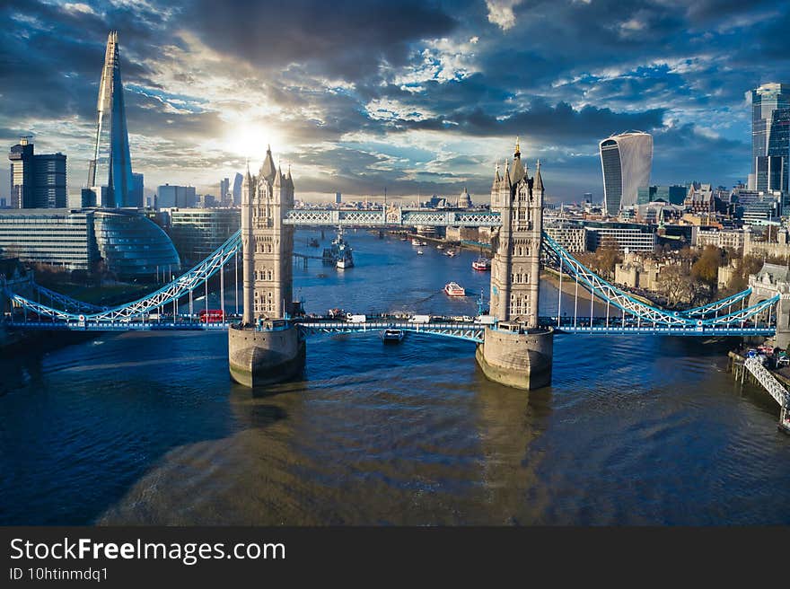 Stunning aerial view of London with Thames river, Shard and tall skyscrapers under the cloudy sky