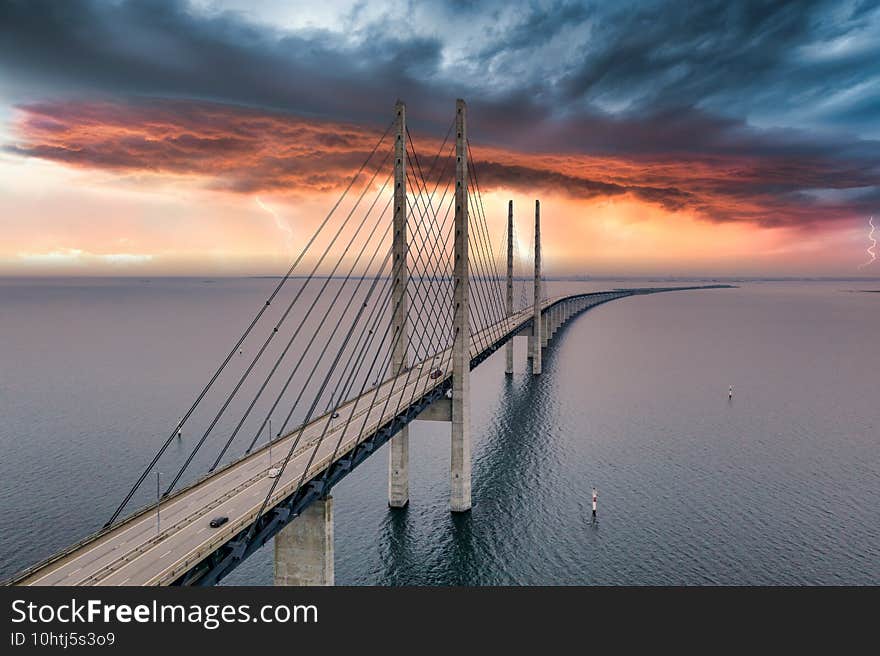 Mesmerizing aerial view of the bridge between Denmark and Sweden under the cloudy sky