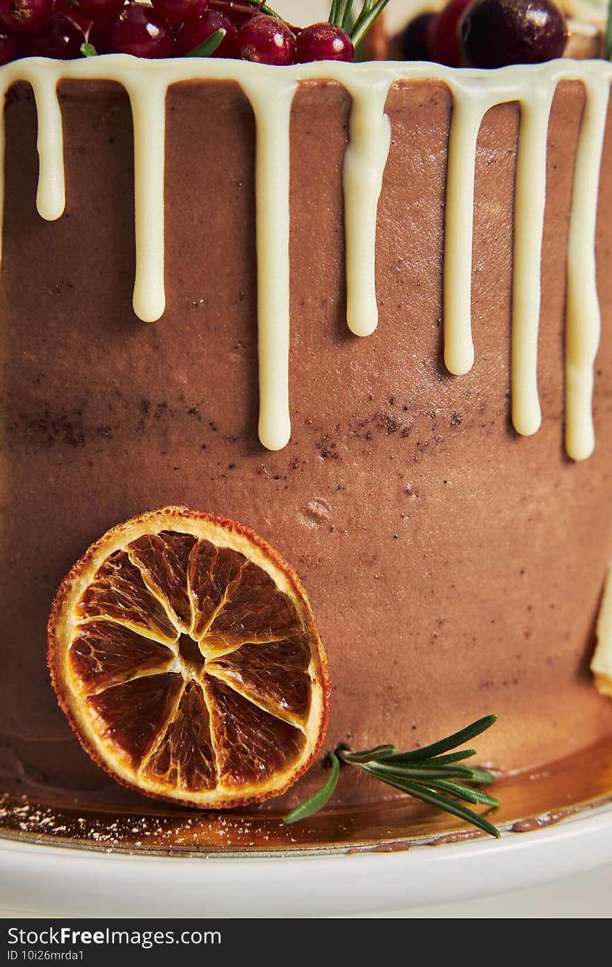 Vertical closeup shot of white dip on a beautiful chocolate cake